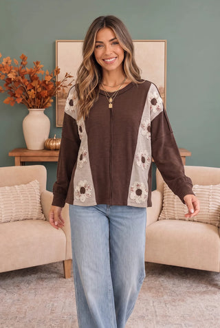 Side view of the brown floral patchwork knit top showing sleeve and panel detail