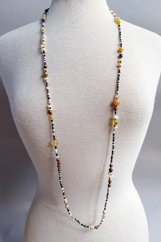 Beaded necklace on a mannequin with a plain background