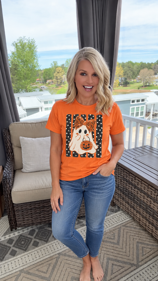 Model wearing orange Halloween ghost trick or treat graphic tee