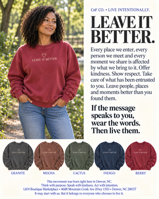 A promotional apparel graphic featuring a woman outdoors wearing a heathered burgundy T-shirt with the printed phrase 'LEAVE IT BETTER.' and a small heart logo.