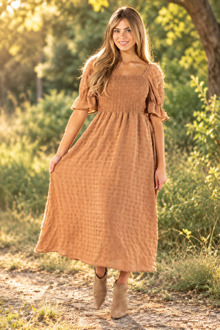 Model wearing a tan Simply Southern textured maxi dress with a square neckline, smocked bodice, and ruffle-trim puff sleeves.