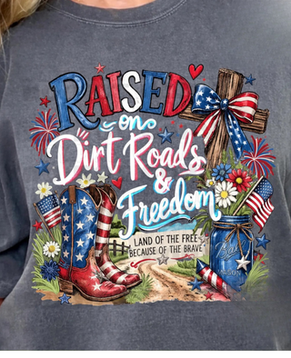 Gray t-shirt with patriotic graphic featuring boots, flowers, and text on a person wearing it.